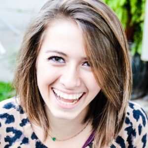 Portrait of girl smiling with short brown hair